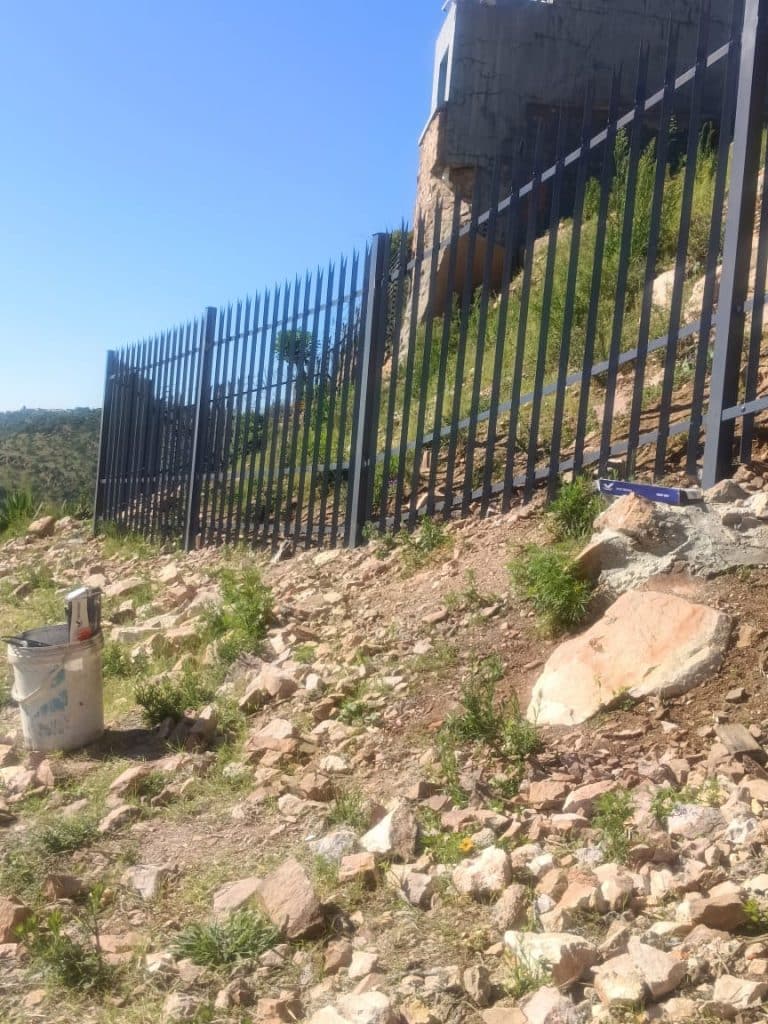 Steel palisade fencing along a residential boundary