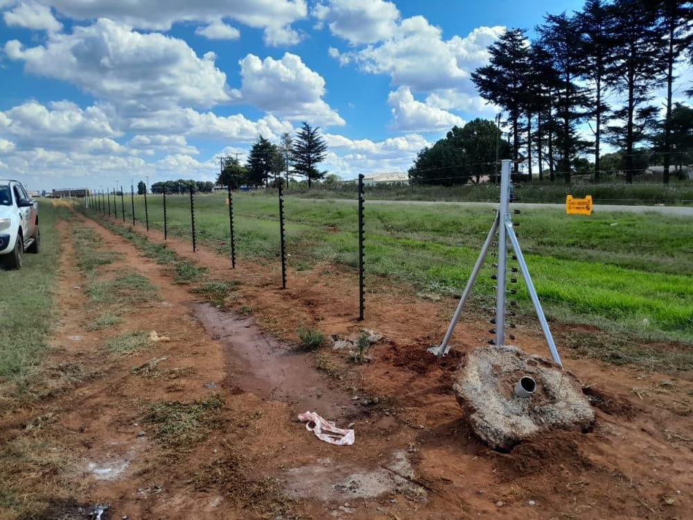 Electric fence line running along a rural property boundary