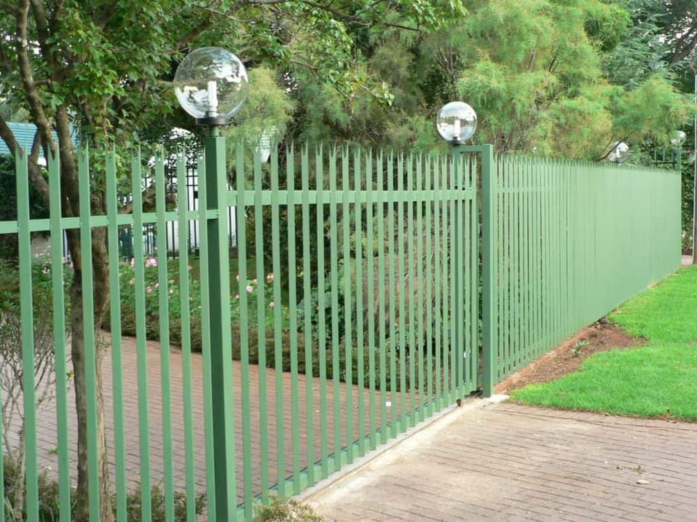Powder-coated palisade fence line along a property boundary