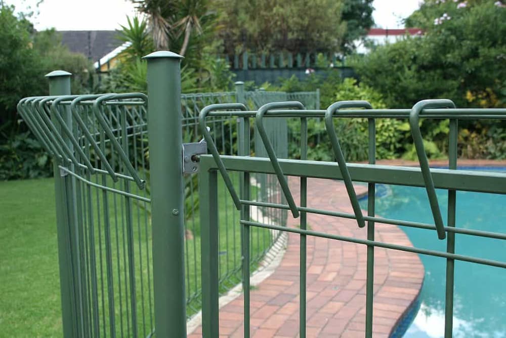 Palisade fencing enclosing a swimming pool area